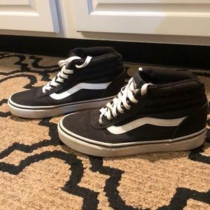 Black slightly high top Vans